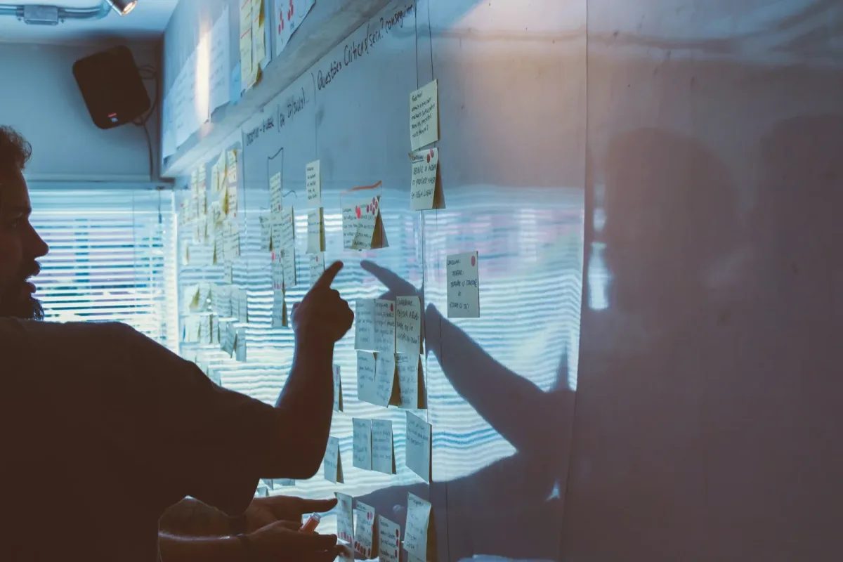 Equipo señalando una propuesta durante una sesión de estrategia de marca Equipo señalando una propuesta durante una sesión de estrategia de marca